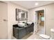 Bathroom featuring dual vessel sinks with black vanity and a framed mirror above at 5615 Arundel Dr, Orlando, FL 32808