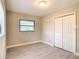 Cozy bedroom with a window and closet, featuring modern flooring and neutral paint at 5615 Arundel Dr, Orlando, FL 32808