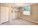 Neutral bedroom with a closet, new vinyl flooring and a large window providing natural light at 5615 Arundel Dr, Orlando, FL 32808