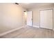 This bedroom features light gray floors and neutral walls, with a closet and passage door at 5615 Arundel Dr, Orlando, FL 32808