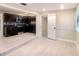 Modern kitchen open to living room space with stainless appliances and dark cabinets at 5615 Arundel Dr, Orlando, FL 32808