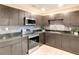 Modern kitchen with stainless steel appliances, sleek cabinets, and a decorative tile backsplash at 5615 Arundel Dr, Orlando, FL 32808