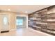 View of the open living space featuring natural light, accent wall, and a glimpse of the exterior at 5615 Arundel Dr, Orlando, FL 32808