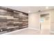 Stylish living room featuring an accent wooden wall, recessed lighting, and bright interior at 5615 Arundel Dr, Orlando, FL 32808