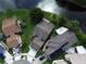 Aerial view of homes with well-maintained lawns, mature trees, and a tranquil lake at 5804 Plum Pudding Ct, Orlando, FL 32821