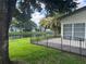 Beautiful backyard features a black metal fence and water views with mature landscaping at 5804 Plum Pudding Ct, Orlando, FL 32821