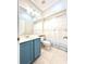 Charming bathroom features blue vanity, tiled floors, and a shower with decorative curtain at 5804 Plum Pudding Ct, Orlando, FL 32821