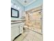Well-lit bathroom features a granite-topped vanity and luxurious tiled walk-in shower at 5804 Plum Pudding Ct, Orlando, FL 32821