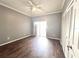 Bright bedroom boasts wood-look floors, a ceiling fan, and sliding glass door access to the outside at 5804 Plum Pudding Ct, Orlando, FL 32821