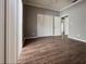 Bedroom with wood-look floors has bright, natural light and a closet with folding doors at 5804 Plum Pudding Ct, Orlando, FL 32821