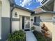 Inviting front entrance with decorative molding, neutral paint, and manicured landscaping at 5804 Plum Pudding Ct, Orlando, FL 32821
