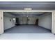 Spacious garage with painted floor, shelving, water heater, side entry door, and an abundance of storage space at 5804 Plum Pudding Ct, Orlando, FL 32821