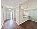 Open-concept living area with wood floors, breakfast bar, and neutral color palette at 5804 Plum Pudding Ct, Orlando, FL 32821