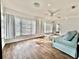 Bright living room has hardwood floors and multiple windows providing plenty of light at 5804 Plum Pudding Ct, Orlando, FL 32821