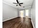 Spacious main bedroom featuring wood floors, a ceiling fan, and an en-suite bathroom at 5804 Plum Pudding Ct, Orlando, FL 32821