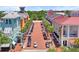 Aerial view of a commercial district featuring palm tree-lined streets, shops, and colorful buildings at 660 Celebration Ave # 250, Kissimmee, FL 34747