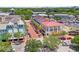 Aerial view of a commercial district featuring palm tree-lined streets, shops, and ample parking at 660 Celebration Ave # 250, Kissimmee, FL 34747