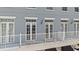 Exterior view of a balcony with white railings and access to the building's exterior via a French door at 660 Celebration Ave # 250, Kissimmee, FL 34747
