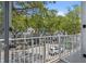 Balcony view overlooking a charming street lined with trees and parked cars on a sunny day at 660 Celebration Ave # 250, Kissimmee, FL 34747