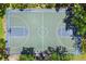 Aerial view of the community basketball court surrounded by trees, a great place to exercise at 660 Celebration Ave # 250, Kissimmee, FL 34747