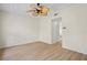 Bright bedroom featuring hardwood floors, a modern ceiling fan, and a doorway to an adjacent bathroom at 660 Celebration Ave # 250, Kissimmee, FL 34747