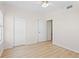 Bright bedroom with light wood floors, closet, and an entry to another room at 660 Celebration Ave # 250, Kissimmee, FL 34747
