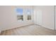 Cozy bedroom featuring light wood floors, bright windows, and closet at 660 Celebration Ave # 250, Kissimmee, FL 34747