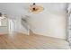 Spacious open-plan living room with wood floors and staircase at 660 Celebration Ave # 250, Kissimmee, FL 34747