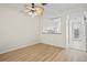 Open-concept room with hardwood flooring, ceiling fan, and a view to the kitchen with a breakfast bar at 660 Celebration Ave # 250, Kissimmee, FL 34747
