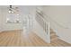 Bright open-plan living room featuring wood floors and a staircase to the upper level at 660 Celebration Ave # 250, Kissimmee, FL 34747