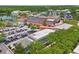 Aerial view of the neighborhood highlighting a large parking lot and lake views at 660 Celebration Ave # 250, Kissimmee, FL 34747