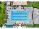 Overhead view of a community pool with lap lanes, lounge chairs, and shaded seating areas at 660 Celebration Ave # 250, Kissimmee, FL 34747