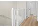 Close-up view of the staircase, with white railings and wood steps at 660 Celebration Ave # 250, Kissimmee, FL 34747