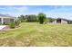 Expansive backyard with ample green space, lovely landscaping, and an outbuilding at 700 Old Geneva Rd, Geneva, FL 32732
