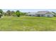 Open backyard showing large, well-maintained lawn and the rear exterior of the home at 700 Old Geneva Rd, Geneva, FL 32732