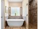 Bathroom featuring a modern soaking tub and a tiled shower at 700 Old Geneva Rd, Geneva, FL 32732
