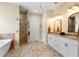 Bathroom features double sinks, stylish mirrors, and a stone-tiled shower at 700 Old Geneva Rd, Geneva, FL 32732