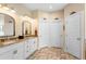 Bathroom featuring double sinks with granite countertops and decorative mirrors at 700 Old Geneva Rd, Geneva, FL 32732