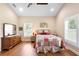 Bedroom showcasing wood floors, a vaulted ceiling, and warm, coordinated décor at 700 Old Geneva Rd, Geneva, FL 32732