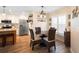 Eat-in kitchen features white cabinets, stainless appliances and wood style tile floors at 700 Old Geneva Rd, Geneva, FL 32732