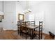 Bright dining room featuring a rustic wooden table set and modern lighting fixture above at 700 Old Geneva Rd, Geneva, FL 32732