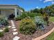 Attractive home surrounded by vibrant landscaping, stepping stone pathway and a covered porch at 700 Old Geneva Rd, Geneva, FL 32732