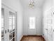 Bright foyer with decorative front door and gorgeous overhead lighting at 700 Old Geneva Rd, Geneva, FL 32732