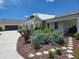Lovely home with a landscaped front yard, stone walkway, and a welcoming covered entrance at 700 Old Geneva Rd, Geneva, FL 32732
