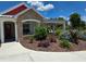 Charming brick home with a covered porch, lush landscaping, and beautiful flower beds at 700 Old Geneva Rd, Geneva, FL 32732