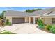 Attached two-car garage with an extended driveway and charming landscaping at 700 Old Geneva Rd, Geneva, FL 32732
