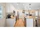Bright kitchen with white cabinets, stainless steel appliances, granite countertops, and a large island with bar seating at 700 Old Geneva Rd, Geneva, FL 32732
