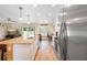 Open kitchen with granite counters, stainless appliances, and an island, seamlessly connects to the living area with sliding doors at 700 Old Geneva Rd, Geneva, FL 32732