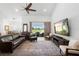 Spacious living room with a large window overlooking a green field and a comfortable leather sofa at 700 Old Geneva Rd, Geneva, FL 32732