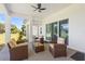 Covered patio features comfortable wicker seating and a ceiling fan for relaxed outdoor living at 700 Old Geneva Rd, Geneva, FL 32732